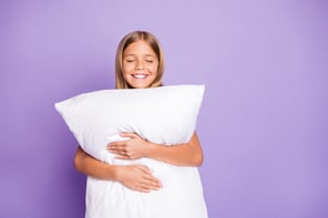 Happy girl with pillow_15%